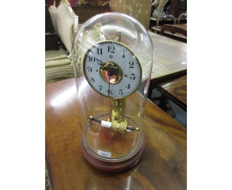 Bulle electric mantel clock, the painted dial with Arabic numerals and visible escapement on a brass column support beneath a