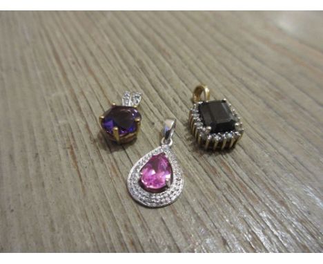 Group of three 9ct gold pendants set sapphire, amethyst and a pink stone 