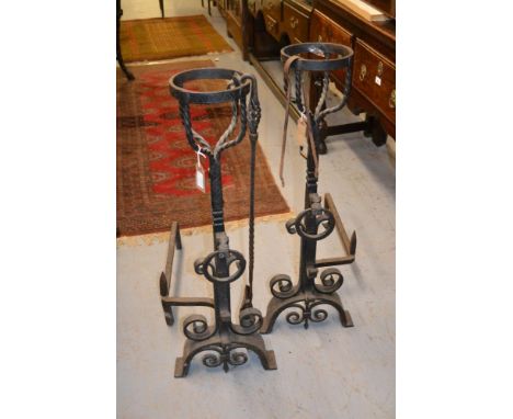 Pair of heavy wrought iron fire dogs with basket tops with maskhead and ring decoration with three iron fire tools, 35.5ins h