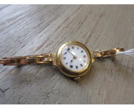 Ladies early 20th Century 18ct gold cased wristwatch with enamel dial and Roman numerals on an associated 15ct gold expanding