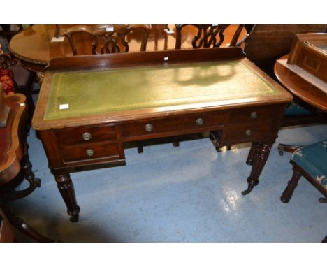 19th Century mahogany writing desk, the green leather inset moulded top above five drawers with brass ring handles and turned