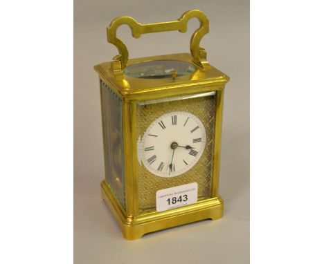 19th Century French gilt brass carriage clock, the enamel dial with Roman numerals and cast surround, the two train half hour