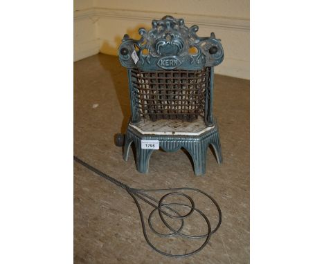 Small enamel decorated iron stove, together with a metal and wooden carpet beater 