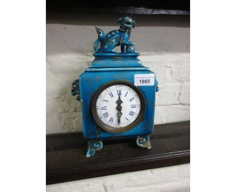 19th Century French pottery mantel clock in chinoiserie style with dog of foe surmount, the circular enamel dial with Roman a