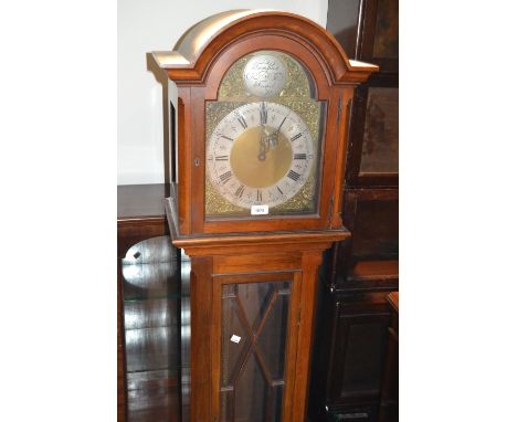 Mid 20th Century mahogany longcase clock with an arched hood above glazed door, raised on bracket feet, the silvered and bras