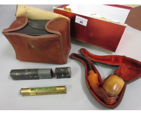 19th Century Meerschaum pipe carved in the form of a hand in a leather case, together with a small cased brass spirit level a