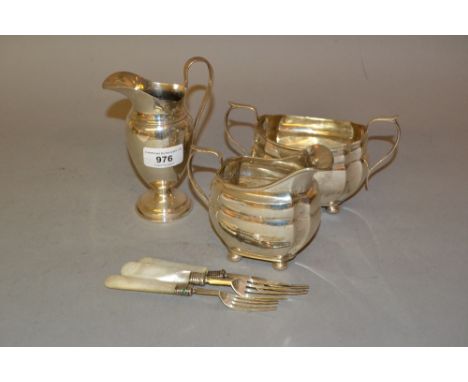 Silver pedestal cream jug, silver cream jug and matching sugar basin, together with three silver and mother of pearl dessert 