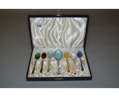 Set of six sterling silver gilt and coloured enamel coffee spoons, together with a matching sugar spoon in a fitted case 