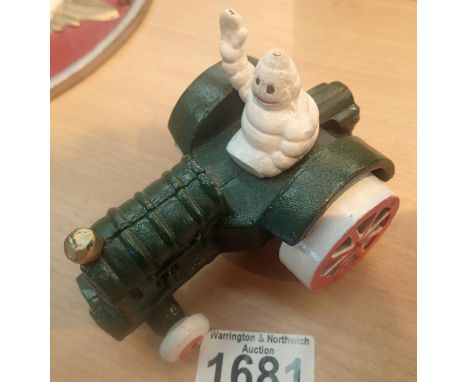 Cast iron Michelin Man on green tractor, L: 11 cm. P&amp;P Group 1 (£14+VAT for the first lot and £1+VAT for subsequent lots)