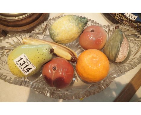 A cut glass bowl containing seven pieces of ceramic fruit, banana, L: 14 cm. Not available for in-house P&amp;P, contact Paul