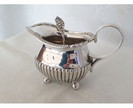 A silver sauce boat with ball feet, London 1899. Approx 153g with a continental silver sauce ladle.