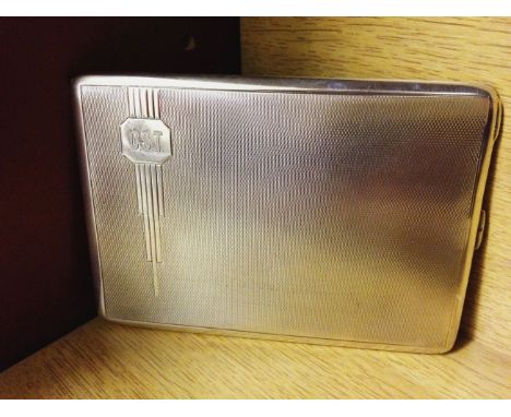 A HM silver cigarette case with Art Deco decoration to front on engine turned background. Approx weight 145g. Birmingham 1933