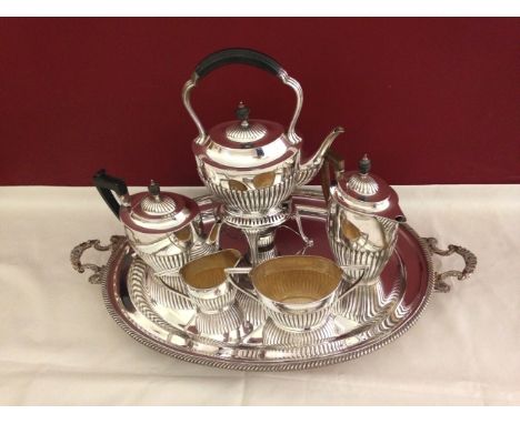 A composite 5 piece silver tea service all in the same half fluted oval shape with ebony handles and finials, comprising 1) S