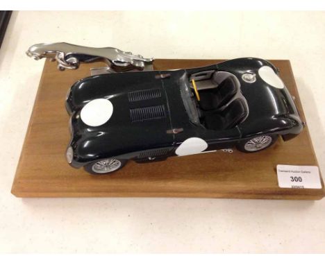 1/18 scale die cast model of C Type Jaguar mounted on a wooden plaque with a Jaguar bonnet mascot. Has good engine detail. No