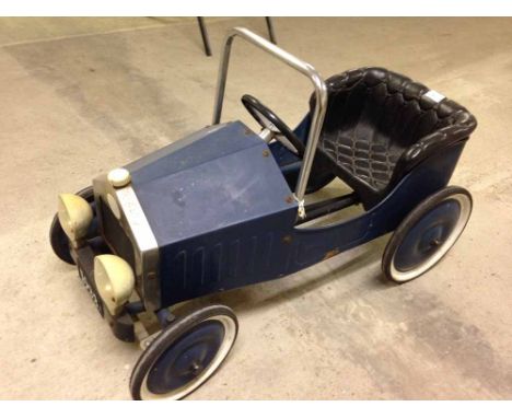 A vintage blue childs pedal car.