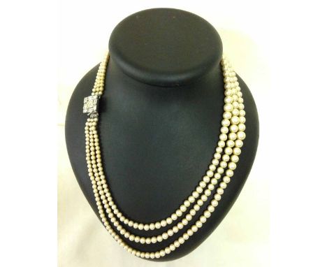 A vintage cased 3 string faux pearl necklace with baguette diamante clasp. Approx 22 inches.