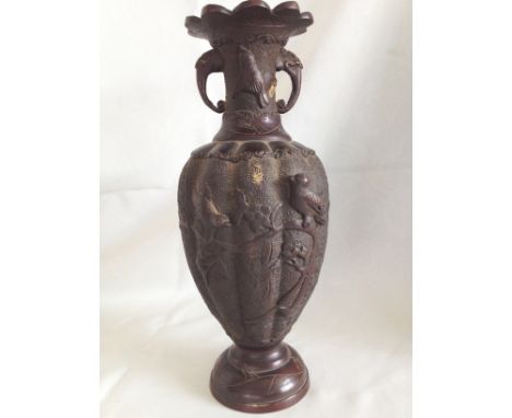 A late 19th century Japanese bronze vase with birds in relief and elephant head decoration to neck.