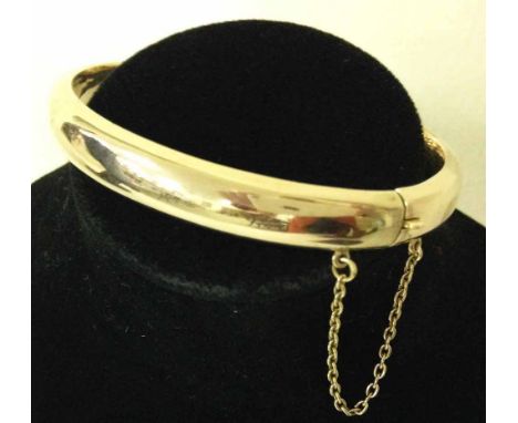 A 9ct gold Victorian smooth bangle with safety chain approx. 10.9g - not hallmarked, tests as 9ct.