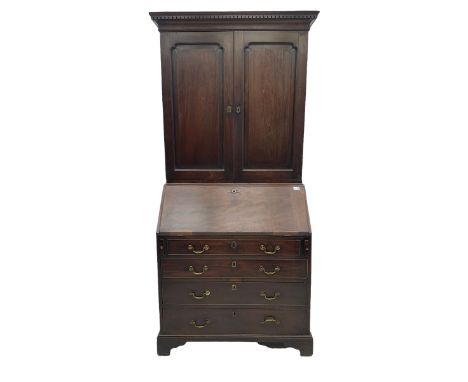 George III walnut bookcase on bureau, dentil cornice over two panelled doors, fall front bureau with fitted interior and four