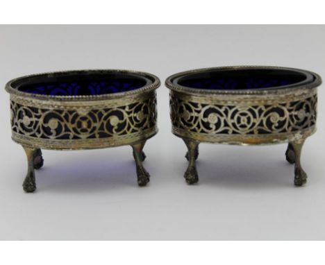 A pair of George III silver salts, oval form with beaded rims, pierced galleries, raised on tall supports with ball &amp; cla