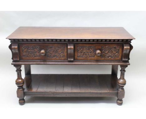 A Jacobean design oak side table, panel front moulded drawers with brass pear drop handles, platform shelf below, 82.5cm high