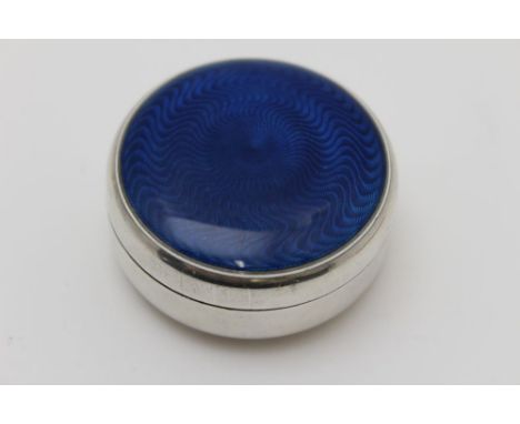 A circular silver pill box, the cover with blue guilloche enamel panel, 5.5cm diameter, gross 59g 