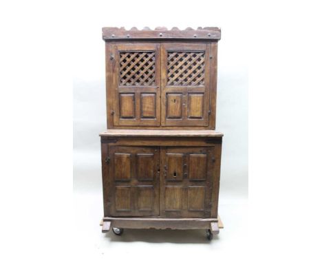 An early 17th century low Countries oak &amp; probably chestnut food cupboard, top with studded shaped frieze over two doors,