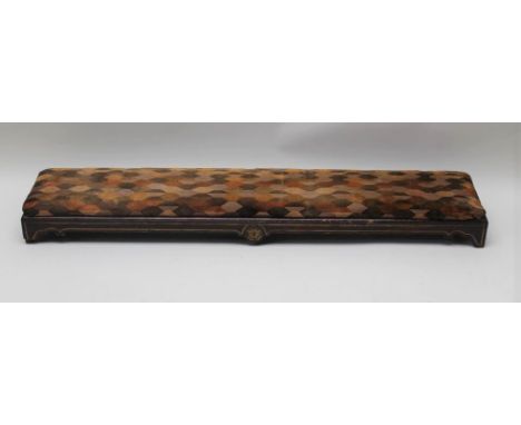 A Victorian long footstool / kneeler, rosewood effect frame, gilded with a carved roundel, raised on bracket feet, upholstere
