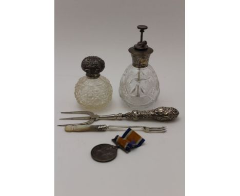 A sterling silver mounted cut glass scent atomiser, a silver mounted cut glass grenade form scent, embossed cover, 8.5cm high