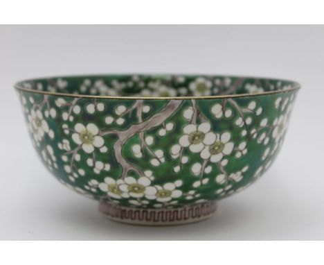 An Oriental ceramic bowl, blossom decoration on green ground, seal mark to base, 18.5cm in diameter 