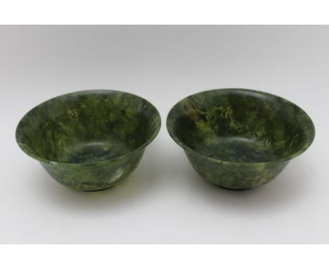 A pair of Chinese spinach green jade bowls, 12cm in diameter 