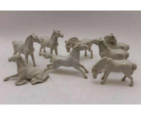 A collection of eight Chinese white glazed ceramic horses, the tallest 9cm high 