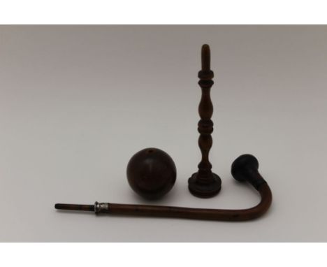 A 19th century treen stick &amp; ball game, the turned handles 18.5cm, together with part of a wooden tobacco pipe 