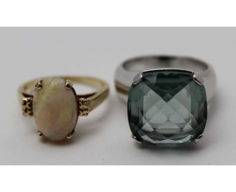 An opal mounted dress ring, single polished cabochon stone on yellow metal band (indistinct mark to interior of band) 3.5g, r