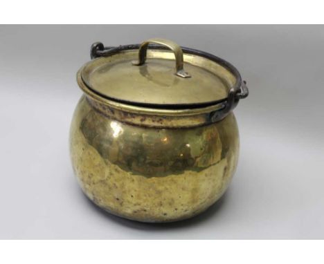 A large brass cauldron or cheese kettle with lid, swing iron handle, c.1800, 45cm diameter 