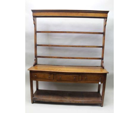 An 18th century design oak dresser, with open Delft rack, base fitted three drawers raised on squared supports with pot board