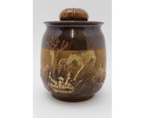 A 20th century Royal Doulton tobacco jar with applied hunting scene, the lid having acorn and oak leaf decoration, believed a