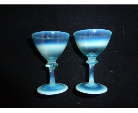 James Powell &amp; Sons, Whitefriars Limited - a rare pair of blue opal liqueur glasses, the conical bowl on bladed knop stem