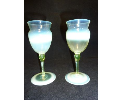 T.G. Jackson for James Powell &amp; Sons, Whitefriars Limited - a pair of straw opal wine glasses, the ovoid bowl with cylind