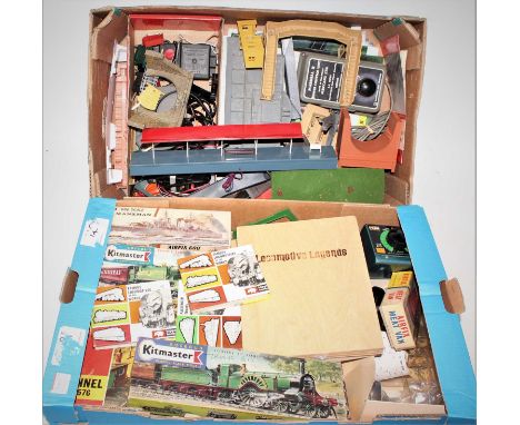 Two trays containing a large quantity of various lineside accessories, control units, plastic kits, scenery, and lineside com