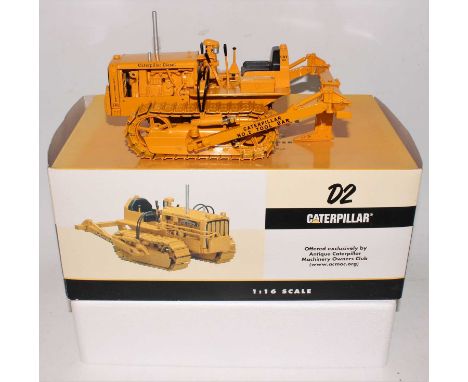 A Speccast 1/16 scale diecast model of a Caterpillar D2 track type tractor (5U series with tool bar ripper) housed in the ori