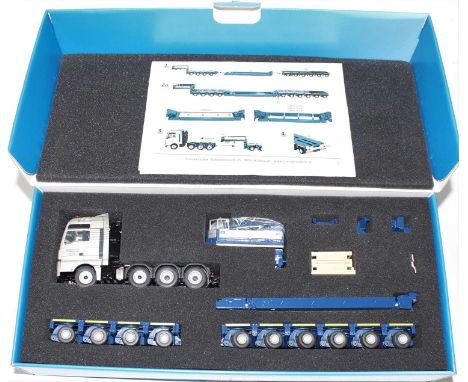 A Conrad 1/50 scale model No. 70177, diecast model of a Man TGX XXL four axle tractor unit with ten axle low loader trailer, 