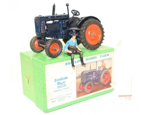 A Britains model No. 128F Fordson Major tractor comprising of dark blue body with orange hubs and rubber tyres, housed in the