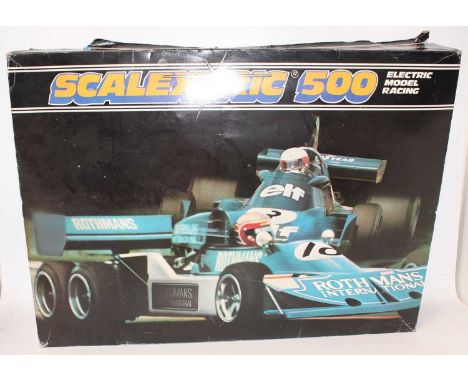 A Scalextric 500 Formula One Racing gift set, comprising of two cars to include a Rothmans No. 10 six-wheel F1 race car, and 