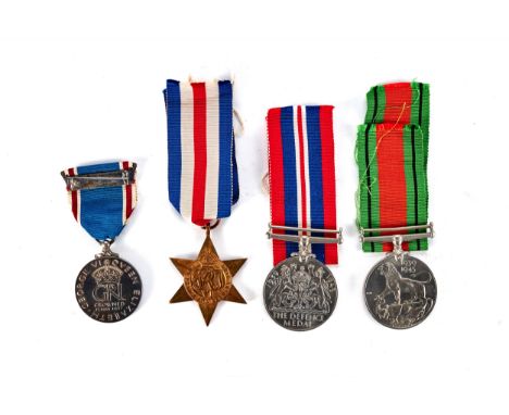 A 1939-45 DEFENCE MEDAL AND WAR MEDAL with ribbons, a George VI France and Germany bronze STAR and a 1937 silver CORONATION M