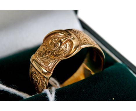 A 9CT YELLOW GOLD FOLIATE ENGRAVED BUCKLE RING, size R, approximately 7 grams.   
