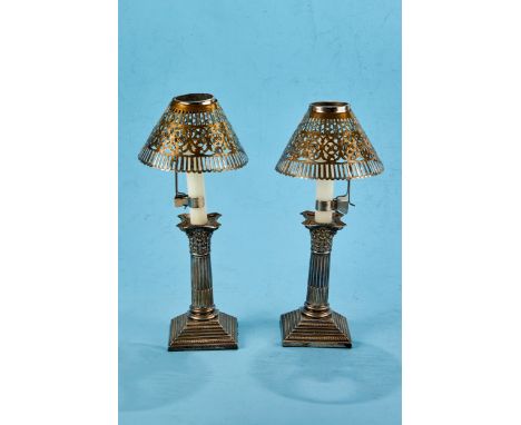 A PAIR OF EDWARDIAN SILVER PLATED CORINTHIAN COLUMN CANDLESTICKS raised on stepped square bases, 6 1/4 ins high with a pair o