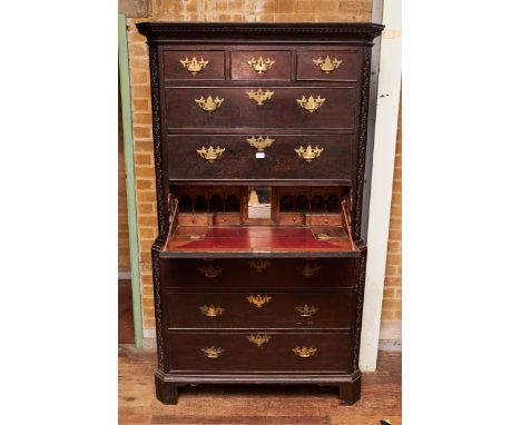 AN 18TH CENTURY CONTINENTAL OAK SECRETAIRE CHEST ON CHEST, the moulded cornice above three short and three long drawers, one 