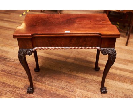 A GEORGE III MAHOGANY CHIPPENDALE STYLE FOLD OVER TOP CARD TABLE, inverted frieze with gadroon moulding raised on foliate car