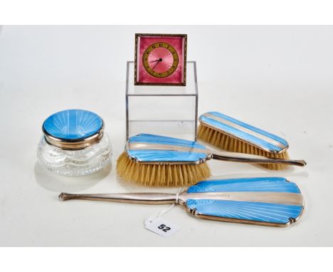 A GEORGE V SILVER AND BLUE GUILLOCHE ENAMEL DRESSING TABLE SET comprising hand mirror, jar and cover, hair brush and clothes 